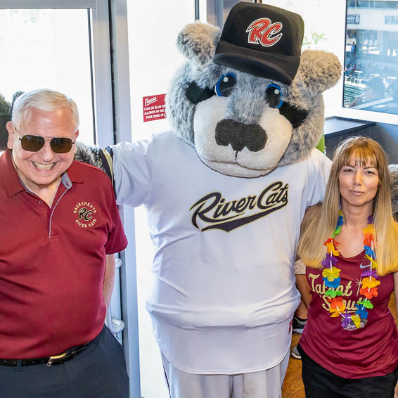 Dave Gordon and Cari Wernicke posing with River Cats mascot