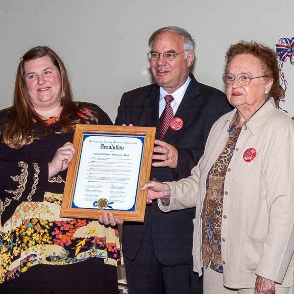 Michele Mickela, Superintendent Meaney, and Elinor Hickey holding framed resolution