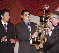 Students receiving trophy from superintendent
