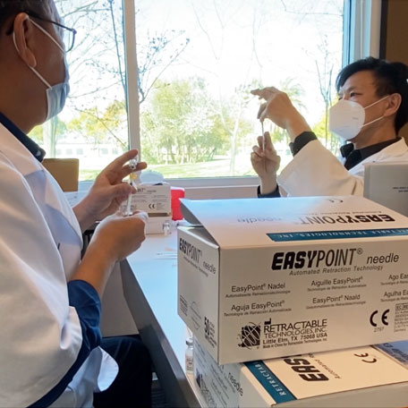 Pharmacists preparing vaccination doses.