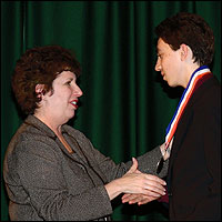 Student shaking hands with administrator