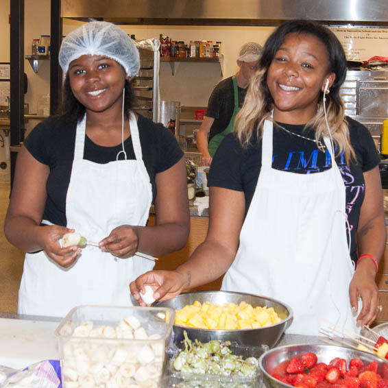 Students preparing fruit sticks