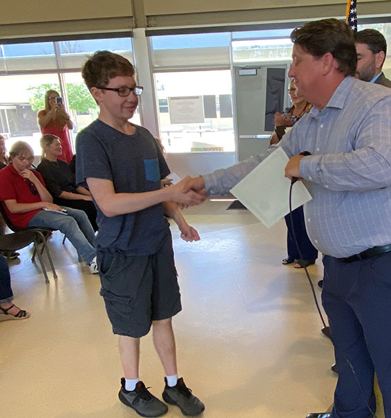 Student shaking hands and receiving a certificate
