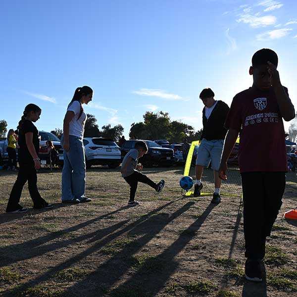 Kids kicking soccer ball