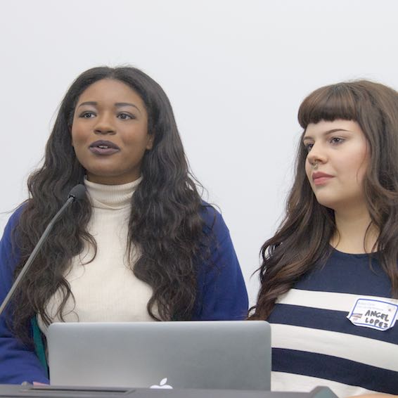 Students presenting in front of computer