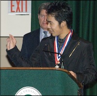 Sho Takatori speaking at podium