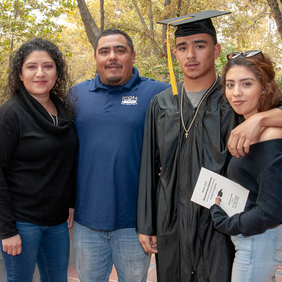 Graduate posing with family