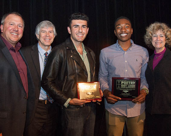 Students holding plaques pose with dignitaries