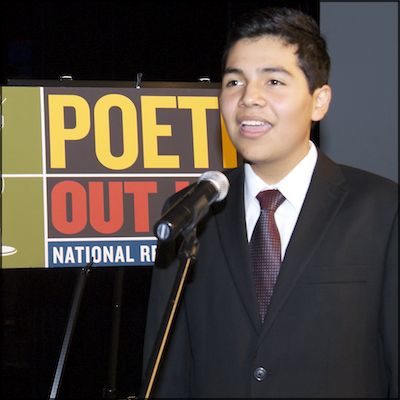 Henry Molina at mic reciting poetry