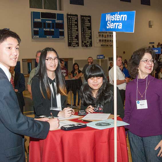 Proctor standing with students during Super Quiz