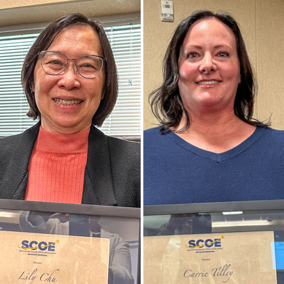 Lily Chu and Carrie Tilley holding framed certificates