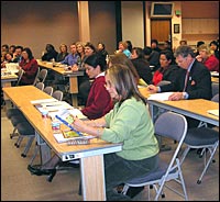 Audience members listen to the presenters