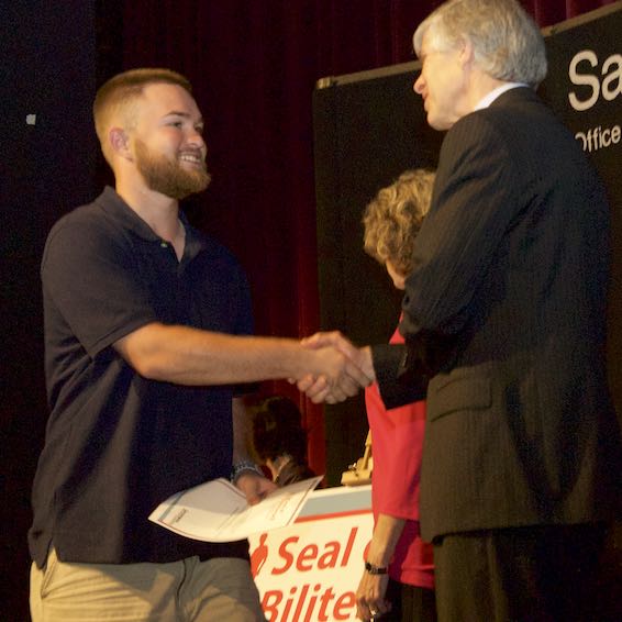 Student shaking hands with Board member