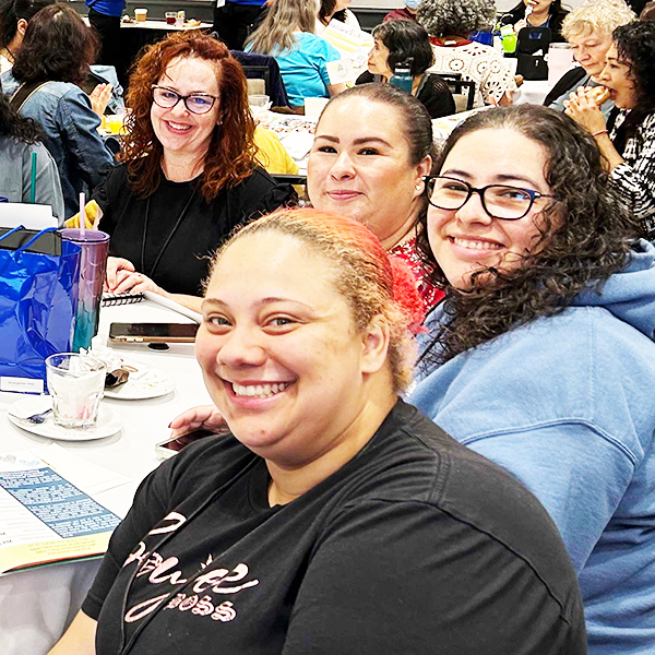 Seated attendees smiling