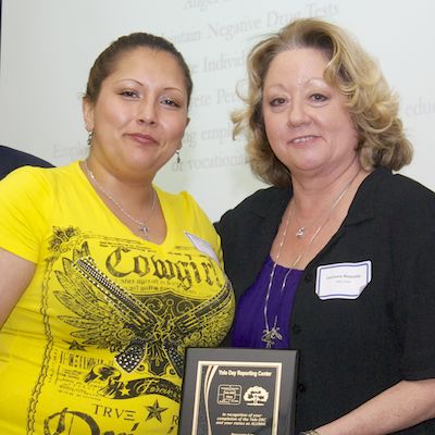 DRC graduate receiving plaque