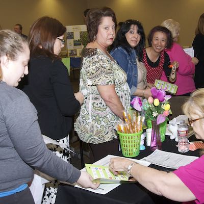 Employees visiting health fair booth