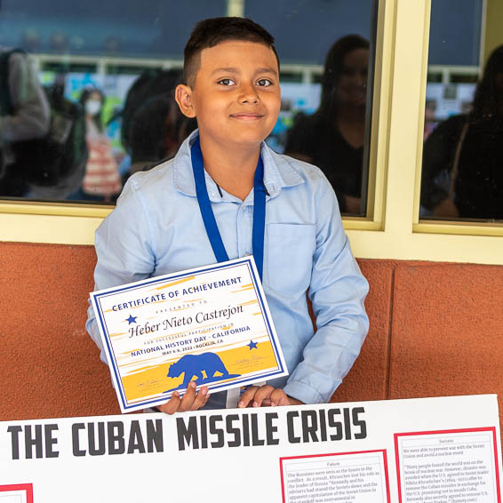 Student posing with Cuban Missile Crisis project