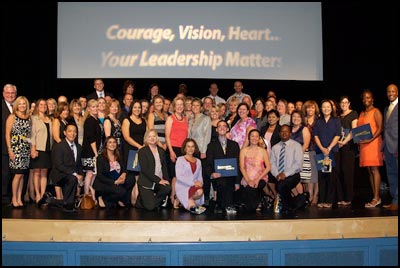 Leadership Institute graduates standing on stage