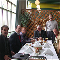 Cafe guests seated at long table