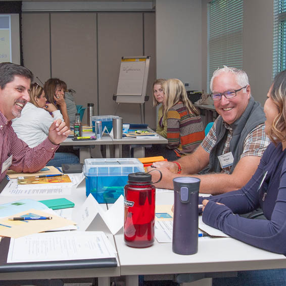 Seated teachers smiling