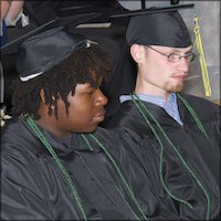 Seated graduates wearing caps and gowns