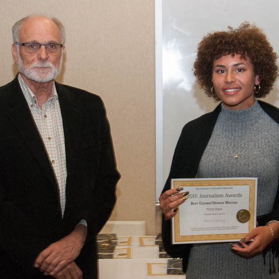 Alexus Briley holding certificate, standing with Walt Yost