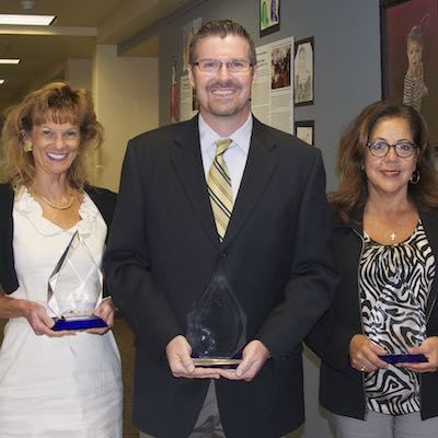 Kathryn Allaman, Brent Givens, and Hilda Fernandez holding awards.