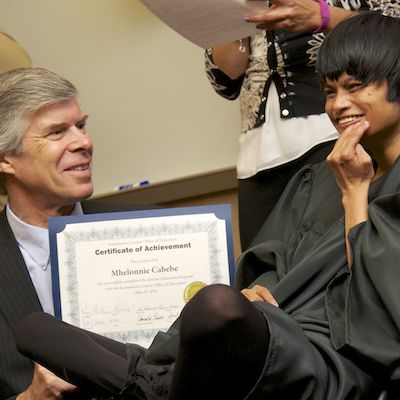 Greg Geeting presenting certificate to graduate