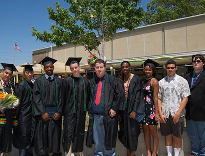 Group of graduates wearing caps and gowns.