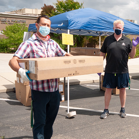 Palmiter staff loading computer boxes into cars.