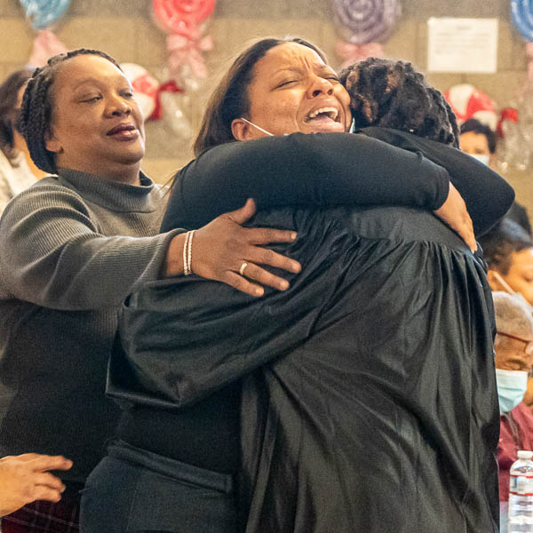 Enthusiastic parent hugging graduate